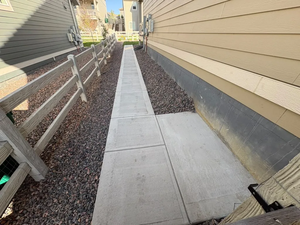 Long concrete side-yard walkway with landing pad