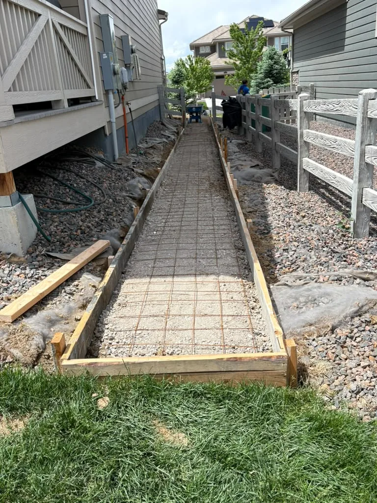 Walkway forms, gravel base and rebar grid ready for concrete